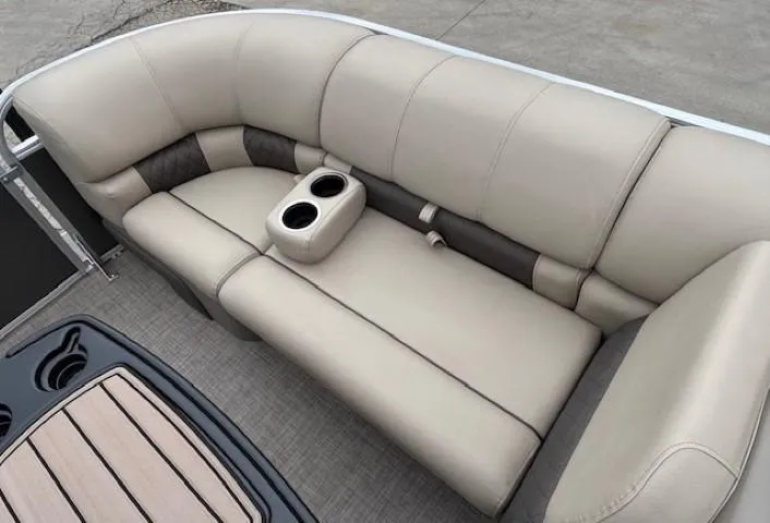 Slide: The Image of 2023 Sun Tracker Party Barge 22 RF XP3 interior with beige seating and cup holders. - 9