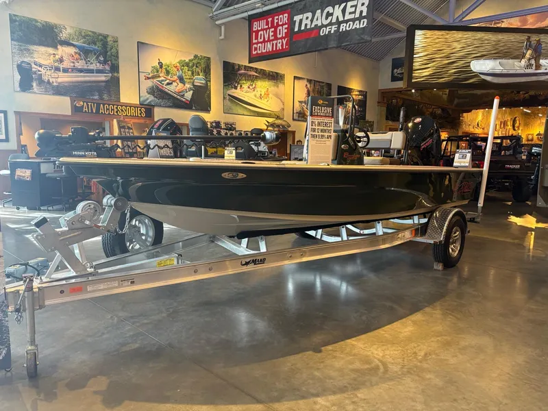 Slide: The Image of 2025 Mako 18 Pro Skiff Backwater Edition displayed in showroom on trailer. - 3