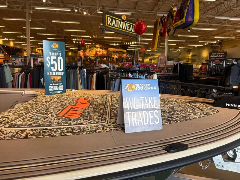 Slide: The Image of 2025 Mako 18 Pro Skiff Backwater Edition displayed in a store with trade-in sign. - 4