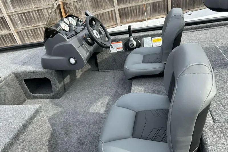 Slide: The Image of 2025 Tracker Pro 170 boat interior with gray seating and control panel. - 10