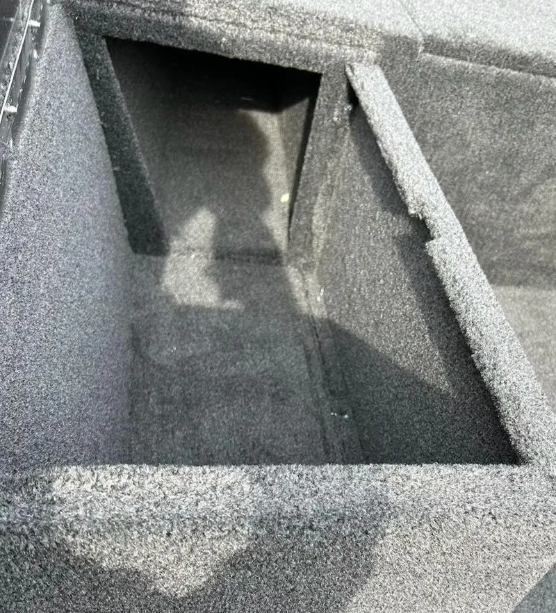 Slide: The Image of 2025 Tracker Pro 170 boat storage compartment with carpeted interior. - 11