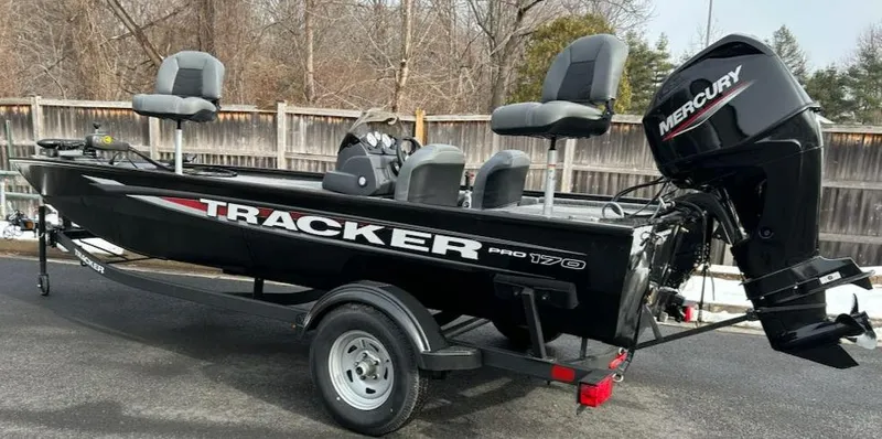 Slide: The Image of 2025 Tracker Pro 170 boat with Mercury engine, parked on a trailer. - 2
