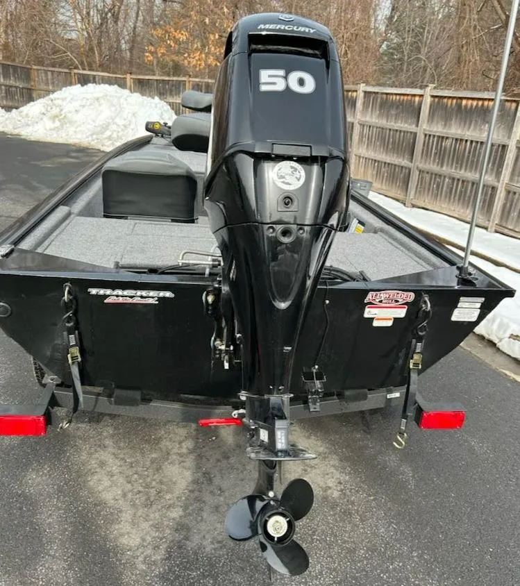 Slide: The Image of 2025 Tracker Pro 170 boat with Mercury 50 engine, parked on a snowy driveway. - 4