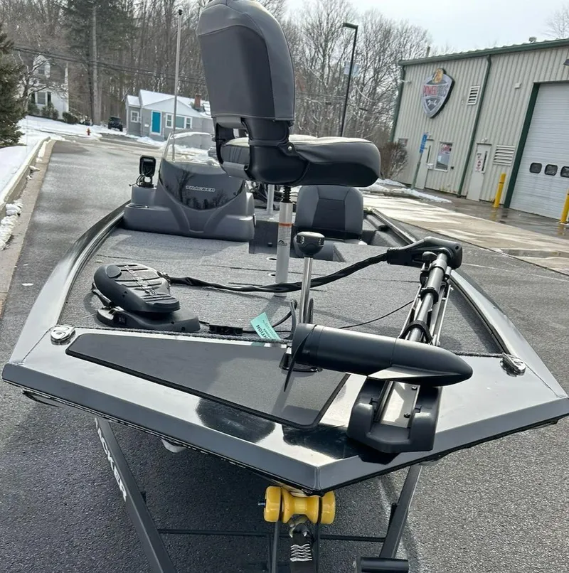 Slide: The Image of 2025 Tracker Pro 170 boat with modern seating and equipment, parked outdoors near a building. - 8