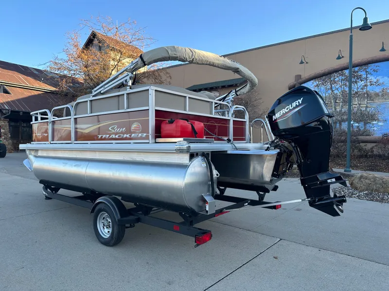 Slide: The Image of 2025 Sun Tracker Bass Buggy 16 XL Select pontoon boat with Mercury outboard motor. - 2