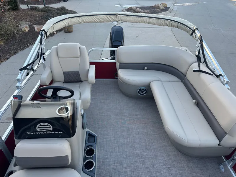 Slide: The Image of 2025 Sun Tracker Bass Buggy 16 XL Select pontoon boat interior with seating and steering console. - 3