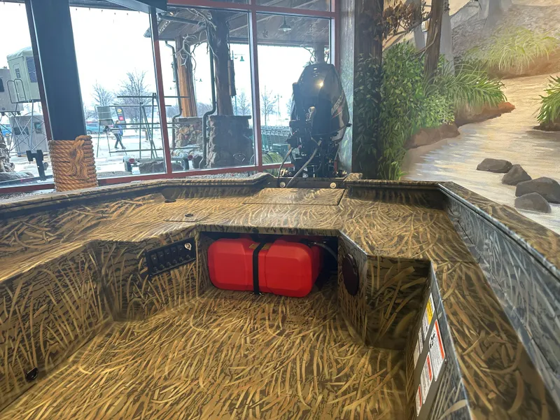 Slide: The Image of 2025 Tracker Grizzly 1650 T Prairie Wings Edition boat interior with camouflage design. - 2