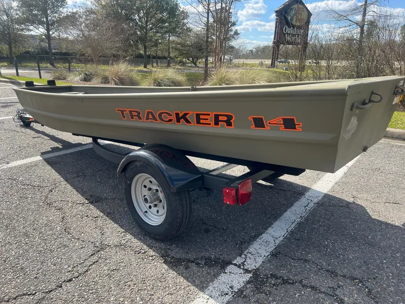 Slide: The Image of 2025 Tracker Grizzly 1436 Utility boat on trailer in parking lot. - 2