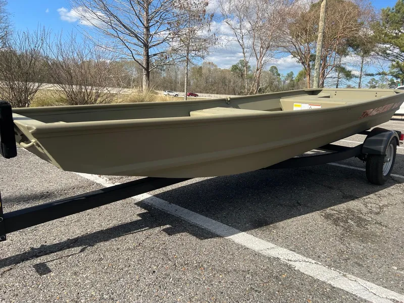 Slide: The Image of 2025 Tracker Grizzly 1436 Utility boat on trailer in parking lot. - 3