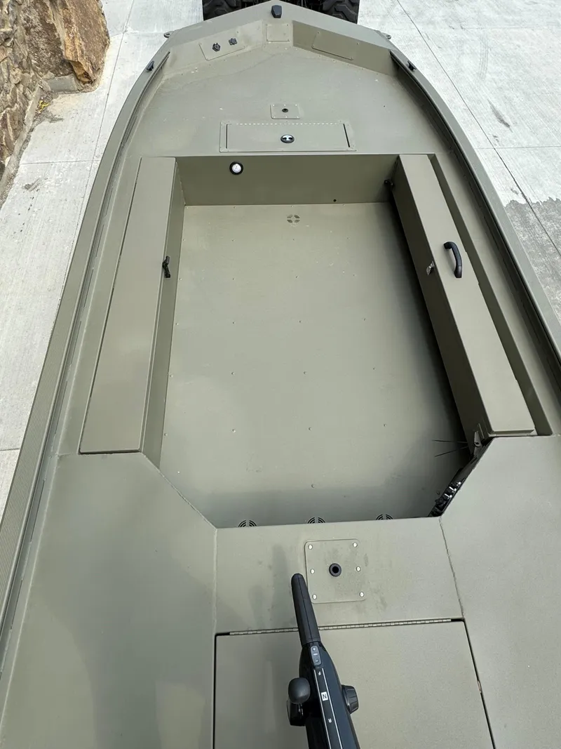 Slide: The Image of 2025 Tracker Grizzly 1654 T Sportsman boat interior, showcasing storage compartments and seating area. - 3