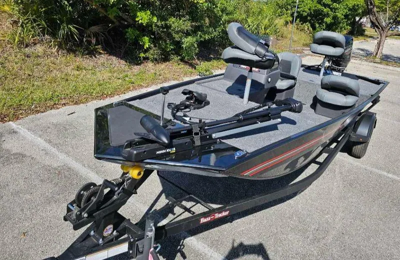 Slide: The Image of 2025 Tracker Bass Tracker Classic XL boat with seating and fishing equipment on a trailer. - 2