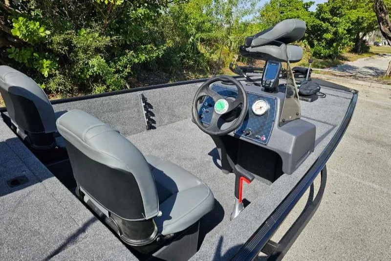 Slide: The Image of 2025 Tracker Bass Tracker Classic XL boat interior with steering wheel and seats. - 6