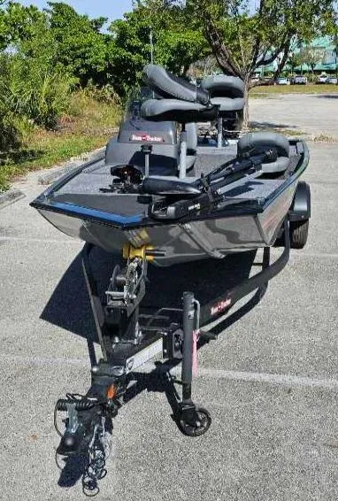 Slide: The Image of 2025 Tracker Bass Tracker Classic XL boat on trailer in sunny parking lot. - 7