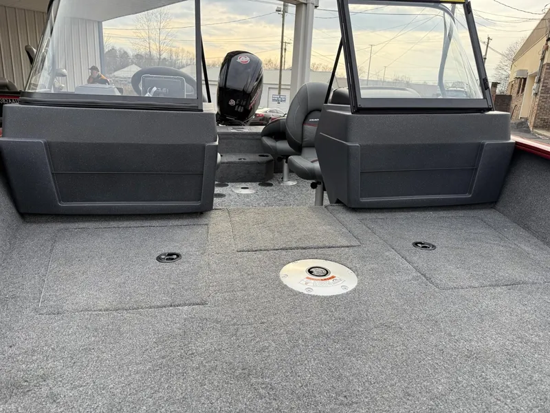 Slide: The Image of 2025 Tracker Pro Guide V-175 WT boat interior with seating and carpeted flooring. - 11