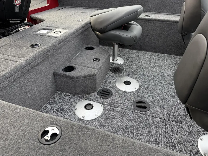 Slide: The Image of 2025 Tracker Pro Guide V-175 WT boat interior with gray seating and carpeted flooring. - 12