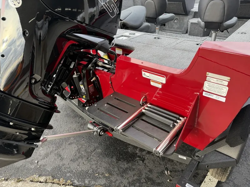 Slide: The Image of 2025 Tracker Pro Guide V-175 WT boat with motor and foldable ladder, red and black design. - 15