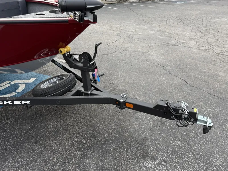 Slide: The Image of 2025 Tracker Pro Guide V-175 WT boat trailer hitch on asphalt. - 2