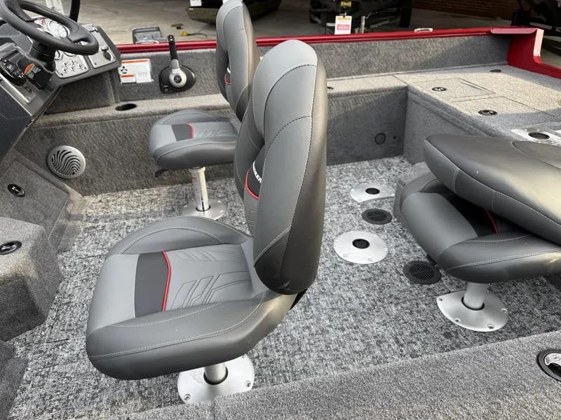 Slide: The Image of 2025 Tracker Pro Guide V-175 WT boat interior with gray seating and carpeted flooring. - 7