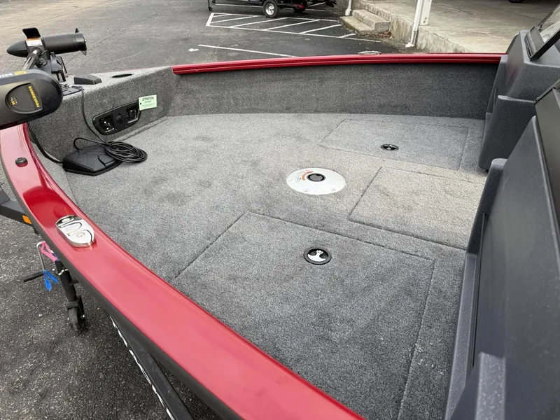 Slide: The Image of 2025 Tracker Pro Guide V-175 WT boat interior with red trim and carpeted deck. - 8