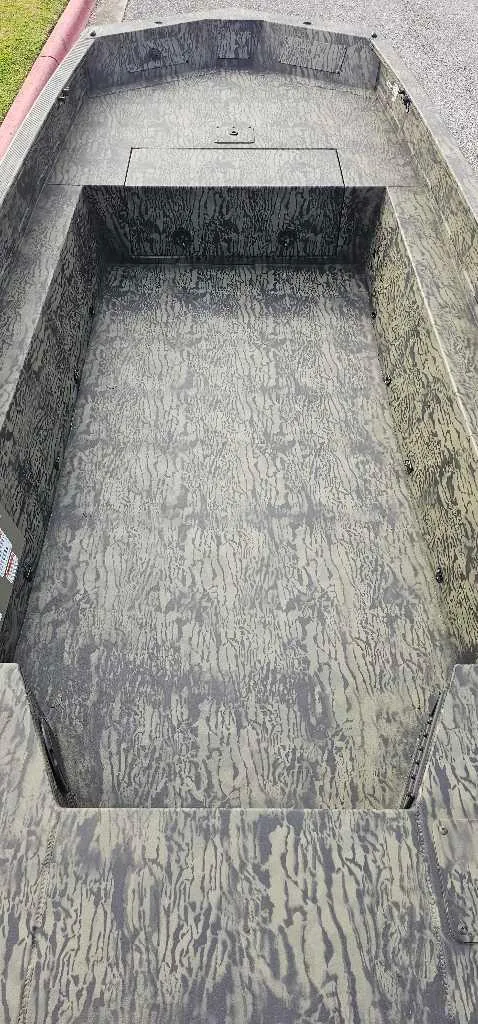 Slide: The Image of 2025 Tracker Grizzly 1650 T Prairie Wings Edition boat interior, camouflage design. - 3