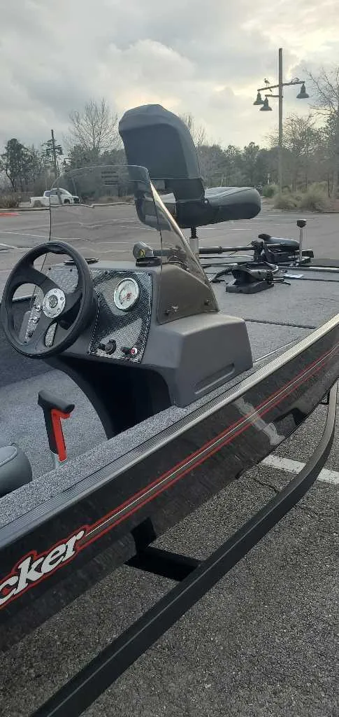 Slide: The Image of 2025 Tracker Bass Tracker Classic XL boat interior with steering wheel and controls. - 3