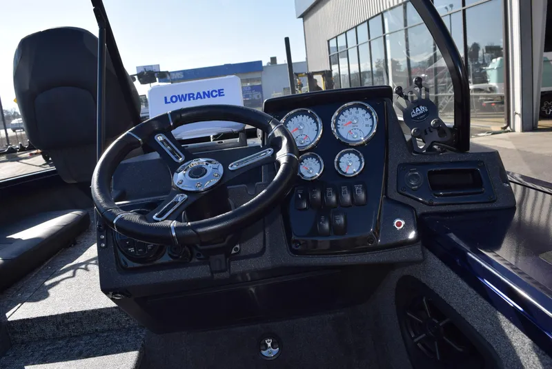 Slide: The Image of 2025 Tracker Targa V-19 Combo boat dashboard with steering wheel and gauges. - 10