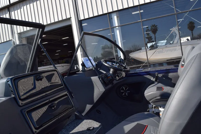 Slide: The Image of 2025 Tracker Targa V-19 Combo boat interior with steering wheel and seating. - 8