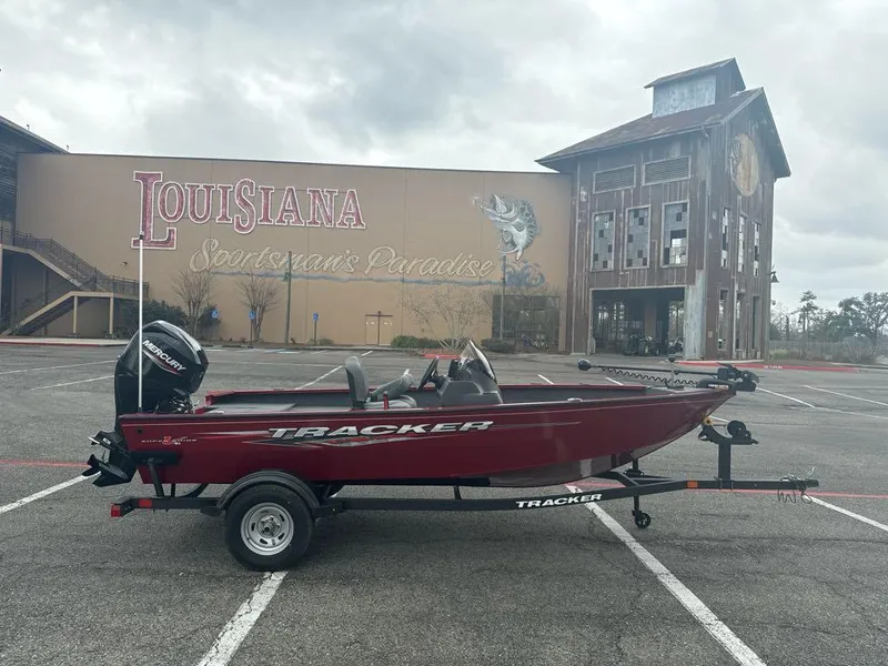 Slide: The Image of 2025 Tracker Super Guide V-16 SC boat in parking lot, Louisiana backdrop. - 2