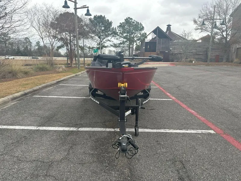 Slide: The Image of 2025 Tracker Super Guide V-16 SC boat parked in an empty lot on a cloudy day. - 3