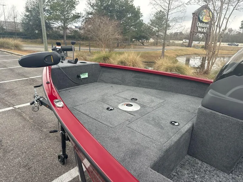 Slide: The Image of 2025 Tracker Super Guide V-16 SC boat in parking lot, featuring spacious deck and trolling motor. - 4