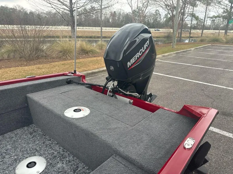 Slide: The Image of 2025 Tracker Super Guide V-16 SC boat with Mercury outboard motor in a parking lot. - 6