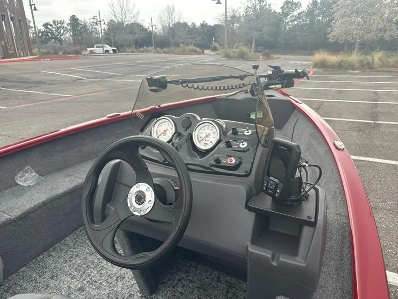 Slide: The Image of 2025 Tracker Super Guide V-16 SC boat dashboard in empty parking lot. - 7