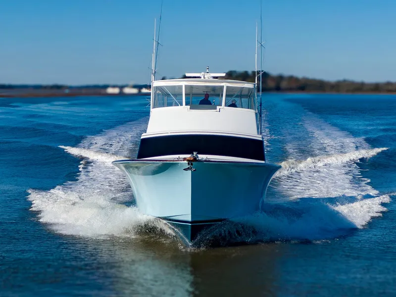 Slide: The Image of 2005 Custom Carolina 66 yacht cruising on open water. - 11