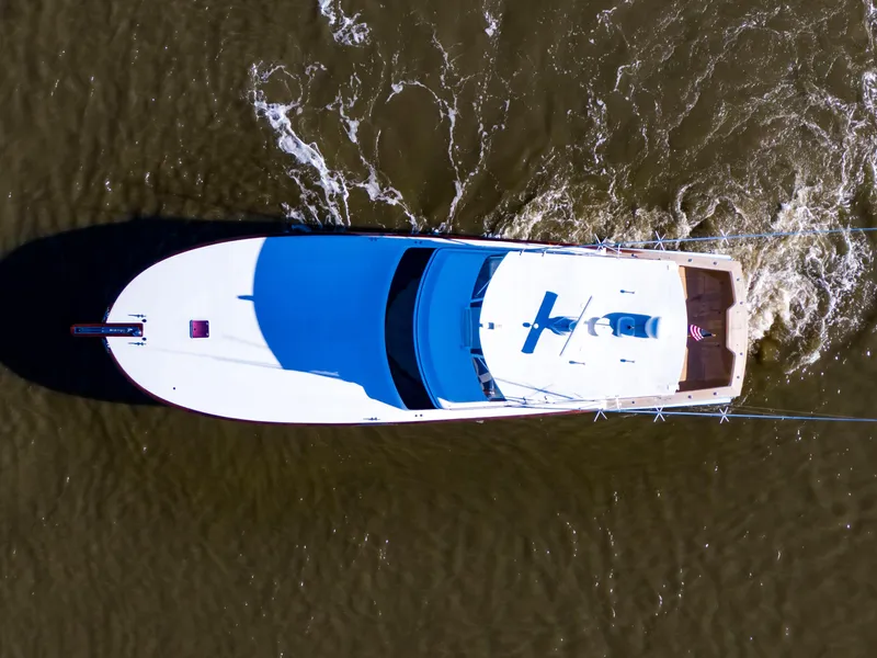 Slide: The Image of Aerial view of 2005 Custom Carolina 66 yacht cruising on water. - 12