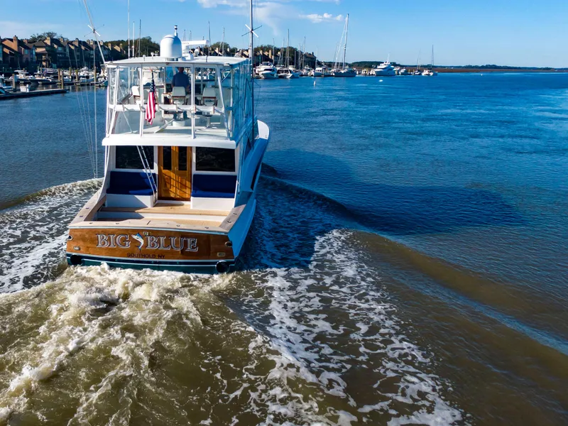 Slide: The Image of Custom Carolina 66 yacht from 2005 cruising in a marina. - 13