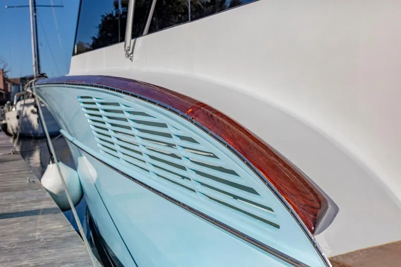 Slide: The Image of 2005 Custom Carolina 66 yacht detail with sleek design and wooden accents. - 19