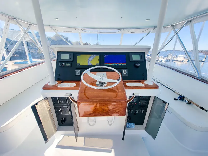 Slide: The Image of 2005 Custom Carolina 66 yacht helm with dual screens and wooden steering wheel. - 22