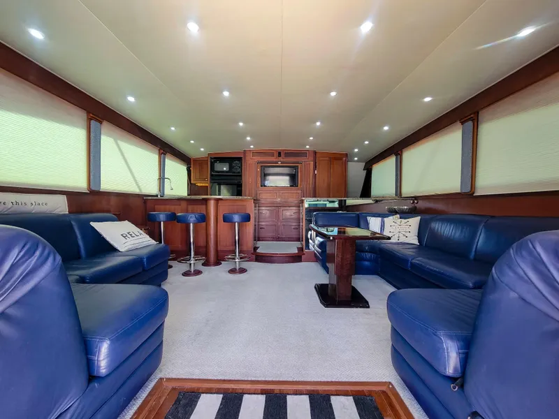 Slide: The Image of Luxurious interior of 2005 Custom Carolina 66 yacht with blue leather seating and modern amenities. - 23