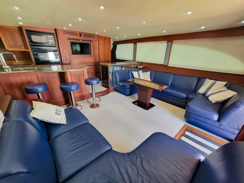 Slide: The Image of Luxurious interior of 2005 Custom Carolina 66 yacht with blue leather seating and modern amenities. - 24