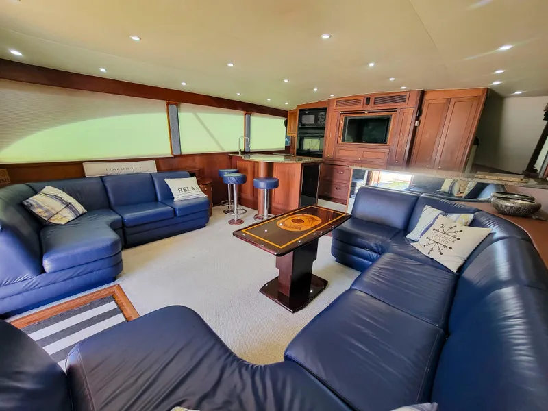 Slide: The Image of Luxurious 2005 Custom Carolina 66 yacht interior with blue leather seating and modern amenities. - 25