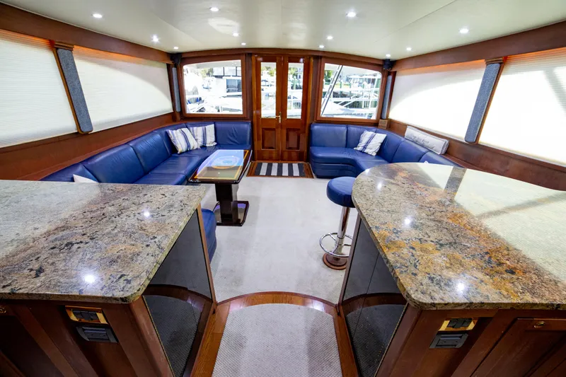 Slide: The Image of Luxurious interior of 2005 Custom Carolina 66 yacht with blue seating and granite countertops. - 27