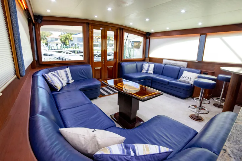 Slide: The Image of Luxurious interior of 2005 Custom Carolina 66 yacht with blue leather seating and elegant decor. - 28