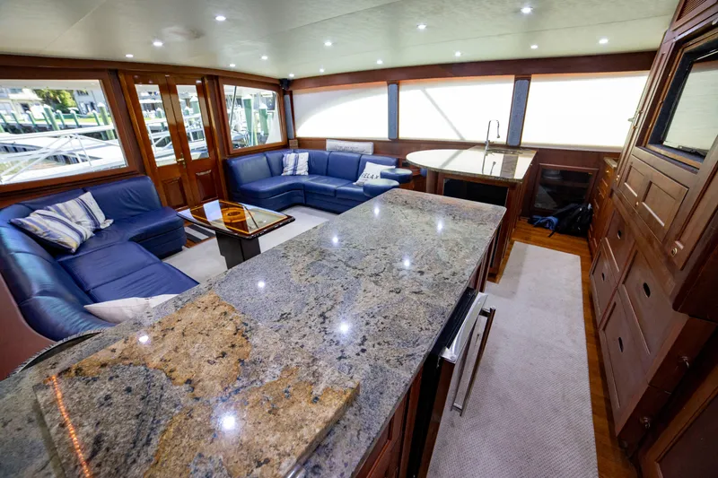 Slide: The Image of Luxurious interior of a 2005 Custom Carolina 66 yacht with granite countertops and plush seating. - 29