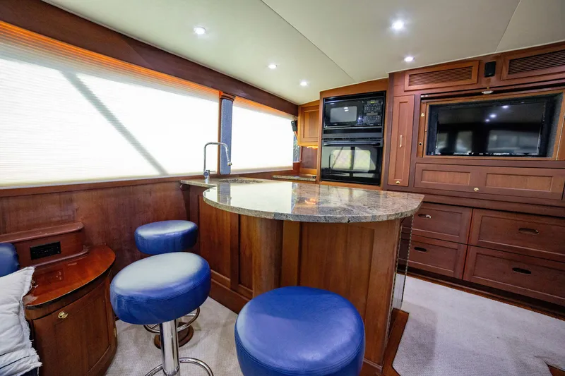 Slide: The Image of Luxurious interior of 2005 Custom Carolina 66 yacht with modern kitchen and seating area. - 30