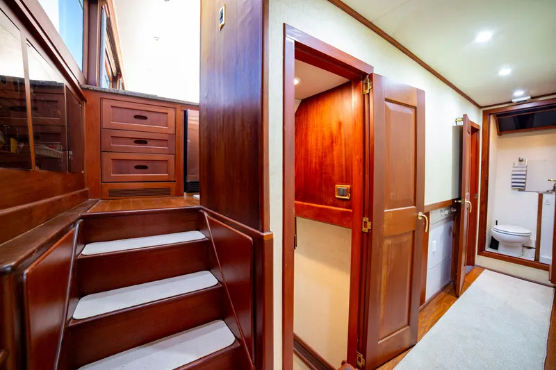 Slide: The Image of Interior of 2005 Custom Carolina 66 yacht with wooden stairs and hallway. - 32