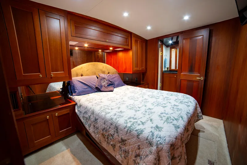 Slide: The Image of Luxurious bedroom interior of 2005 Custom Carolina 66 yacht with wooden cabinetry and cozy bedding. - 33