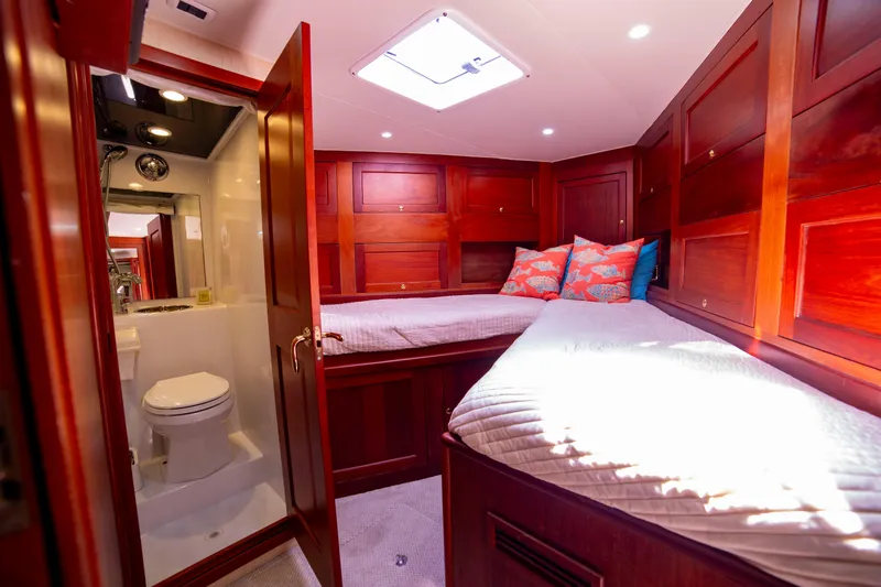 Slide: The Image of Luxurious cabin interior of 2005 Custom Carolina 66 yacht with twin beds and ensuite bathroom. - 34