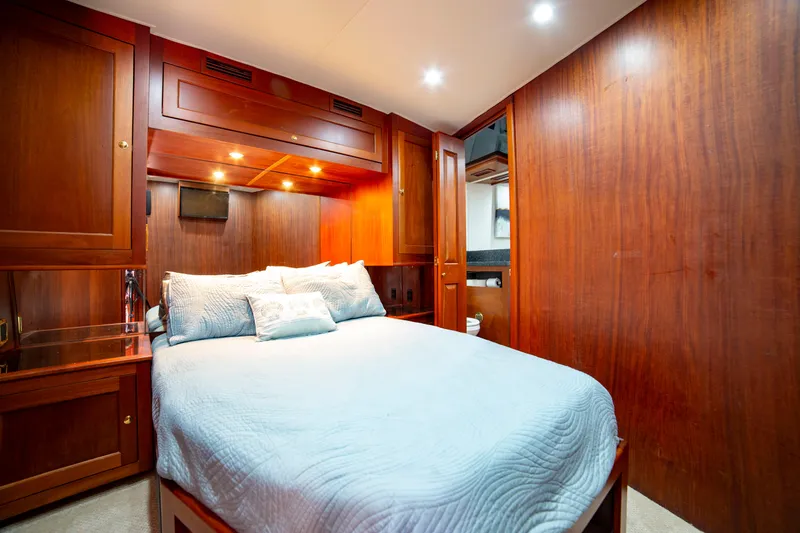 Slide: The Image of Luxurious bedroom in 2005 Custom Carolina 66 yacht with wood paneling and cozy bedding. - 35