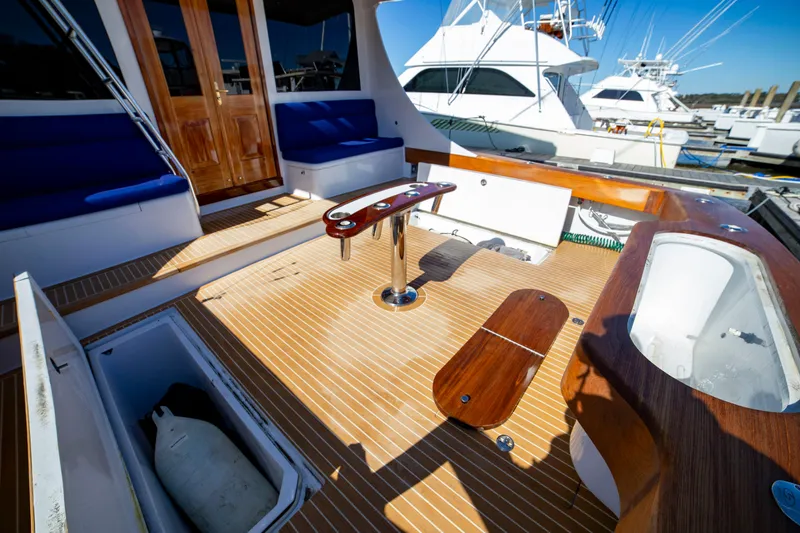 Slide: The Image of Spacious deck of 2005 Custom Carolina 66 yacht with wooden flooring and seating. - 39