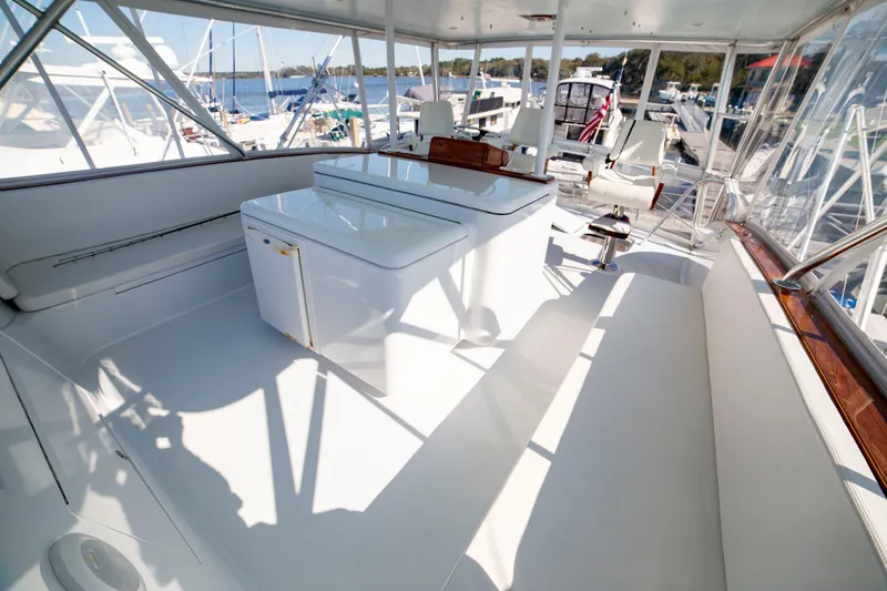 Slide: The Image of Spacious deck of 2005 Custom Carolina 66 yacht, featuring sleek white seating and storage. - 43